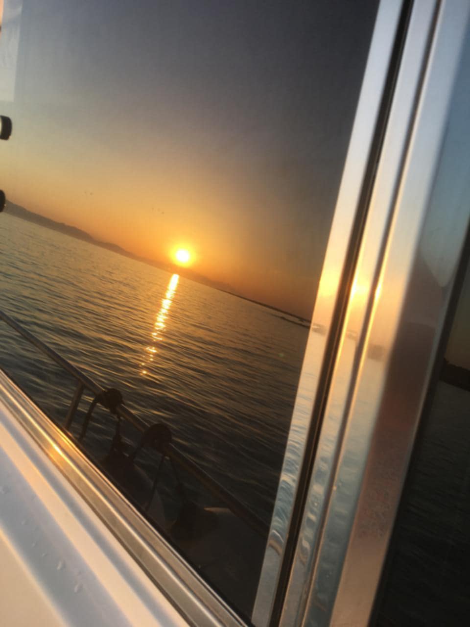 The setting sun reflected in the yacht window